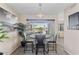 Bright dining area with a modern light fixture, stylish table, and view of the backyard at 6802 S 44Th Pl, Phoenix, AZ 85042