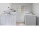 Bright laundry room with a modern washer and dryer set and a window for natural light at 6802 S 44Th Pl, Phoenix, AZ 85042