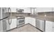Modern kitchen featuring stainless steel appliances, white cabinets, and stone countertops at 750 E Northern Ave # 2006, Phoenix, AZ 85020