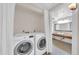 Functional laundry area with side by side washer and dryer, alongside a sink and vanity at 750 E Northern Ave # 2006, Phoenix, AZ 85020