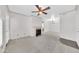 Cozy living room showcasing a fireplace, ceiling fan, and neutral-toned walls at 750 E Northern Ave # 2006, Phoenix, AZ 85020