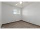 Neutral bedroom showcases a brick accent wall and window with blinds, plus tile flooring at 8211 E Garfield St # J219, Scottsdale, AZ 85257