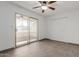 Minimalist bedroom with tile floors, ceiling fan, and a sliding glass door to a balcony with nice light at 8211 E Garfield St # J219, Scottsdale, AZ 85257