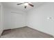 Bedroom features tile flooring and a double closet at 8211 E Garfield St # J219, Scottsdale, AZ 85257