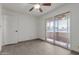 Bright bedroom featuring sliding glass doors leading to the balcony, as well as neutral tile flooring at 8211 E Garfield St # J219, Scottsdale, AZ 85257