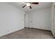 Neutral bedroom offers a blank canvas with tile flooring and a simple ceiling fan and light at 8211 E Garfield St # J219, Scottsdale, AZ 85257