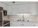 Bright kitchen with white cabinets, tiled countertops, and stainless steel appliances at 8211 E Garfield St # J219, Scottsdale, AZ 85257