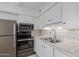 Updated kitchen with stainless steel appliances, and bright white cabinets at 8211 E Garfield St # J219, Scottsdale, AZ 85257