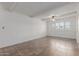 Bright, airy living room with tiled floors, white brick accent wall and a ceiling fan at 8211 E Garfield St # J219, Scottsdale, AZ 85257