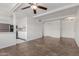 Open-concept living area flowing into kitchen, showcasing tile floors, ceiling fan, and white walls at 8211 E Garfield St # J219, Scottsdale, AZ 85257
