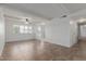 Spacious living room with tiled floors, white brick accents, and natural light at 8211 E Garfield St # J219, Scottsdale, AZ 85257