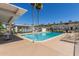 Community pool surrounded by lounge chairs, a gazebo, and palm trees at 8211 E Garfield St # J219, Scottsdale, AZ 85257