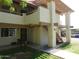 Inviting two-story home featuring a classic door, lush lawn, and an open staircase at 8838 N 8Th St # 105, Phoenix, AZ 85020