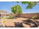 Home's outdoor space, featuring a covered patio, garden, and privacy fence, offers a serene retreat at 888 S 165Th Ln, Goodyear, AZ 85338