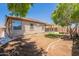 Spacious backyard features a covered patio, landscaping, and ample room for outdoor entertaining at 888 S 165Th Ln, Goodyear, AZ 85338
