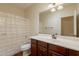 Cozy bathroom features a dark wood vanity, white sink, and a shower with a curtain at 888 S 165Th Ln, Goodyear, AZ 85338