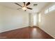Bedroom with dark wood floors, a ceiling fan, and access to the exterior at 888 S 165Th Ln, Goodyear, AZ 85338