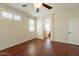 Bedroom with shuttered windows, ceiling fan, and dark wood flooring at 888 S 165Th Ln, Goodyear, AZ 85338