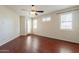 Bedroom with dark wood floors, ceiling fan, and exterior access at 888 S 165Th Ln, Goodyear, AZ 85338