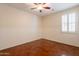 Bedroom featuring wood floors, chair rail and a window with shutters at 888 S 165Th Ln, Goodyear, AZ 85338