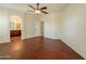 A bright room with wood floors, ceiling fan, and en suite bathroom access at 888 S 165Th Ln, Goodyear, AZ 85338
