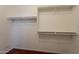 Walk-in closet features white shelving and stained concrete floors at 888 S 165Th Ln, Goodyear, AZ 85338