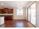 Open dining area with modern chandelier and sliding glass door, adjacent to a bright kitchen at 888 S 165Th Ln, Goodyear, AZ 85338