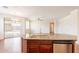 Kitchen island featuring a sink, dishwasher and granite countertops in an open floor plan at 888 S 165Th Ln, Goodyear, AZ 85338