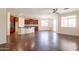 Open concept living room and kitchen with modern lighting and plenty of space to entertain at 888 S 165Th Ln, Goodyear, AZ 85338