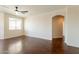 Bright living room features a ceiling fan, large windows, and archway to hallway at 888 S 165Th Ln, Goodyear, AZ 85338