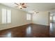 Expansive living room featuring stained concrete floors and large windows with shutters at 888 S 165Th Ln, Goodyear, AZ 85338