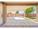 Inviting covered patio area with a pergola, perfect for outdoor living and entertaining with a built-in bench at 888 S 165Th Ln, Goodyear, AZ 85338