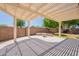Enjoy outdoor living on this expansive covered patio, complete with pergola for shade and a built-in fire pit at 888 S 165Th Ln, Goodyear, AZ 85338
