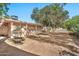 Expansive backyard showcasing mature trees providing shade and a screened-in porch for outdoor living at 10205 W Royal Oak Rd, Sun City, AZ 85351