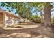 Spacious backyard featuring mature trees and a screened-in porch for outdoor relaxation and entertaining at 10205 W Royal Oak Rd, Sun City, AZ 85351