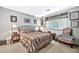Comfortable bedroom with decorative window, carpet floors, and a wrought iron bed frame at 10205 W Royal Oak Rd, Sun City, AZ 85351