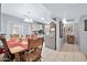 Bright dining area with wood table set for six, adjacent to the kitchen at 10205 W Royal Oak Rd, Sun City, AZ 85351