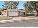 Attractive home showcasing a well-manicured lawn and a spacious two-car garage at 10205 W Royal Oak Rd, Sun City, AZ 85351