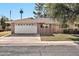 Charming single-story home with a well-maintained yard and a two-car garage at 10205 W Royal Oak Rd, Sun City, AZ 85351