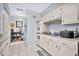 Functional kitchen with white cabinets and appliances, offering a practical cooking space at 10205 W Royal Oak Rd, Sun City, AZ 85351