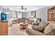 Comfortable living room with classic decor, including a ceiling fan and cozy sofas at 10205 W Royal Oak Rd, Sun City, AZ 85351