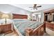 Comfortable main bedroom featuring a wooden bed frame and natural light at 10205 W Royal Oak Rd, Sun City, AZ 85351