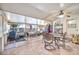 Spacious enclosed patio with concrete floor, screened windows, and dining table at 10205 W Royal Oak Rd, Sun City, AZ 85351