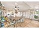 Enclosed patio with concrete floor, ceiling fan, dining table, and double french doors at 10205 W Royal Oak Rd, Sun City, AZ 85351