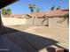 Backyard with decorative rocks, covered patio, and a beige privacy fence at 1249 E Commerce Ave, Gilbert, AZ 85234