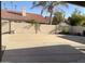 Large backyard featuring a covered pool, block fence, and desert landscaping at 1249 E Commerce Ave, Gilbert, AZ 85234