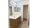 Bathroom featuring a vanity with cabinets, a large mirror, and tile flooring at 1249 E Commerce Ave, Gilbert, AZ 85234