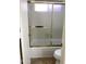 Bathroom with shower and tub, framed by sliding glass doors at 1249 E Commerce Ave, Gilbert, AZ 85234