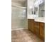 Bright bathroom featuring a glass-enclosed shower and vanity with storage space at 1249 E Commerce Ave, Gilbert, AZ 85234