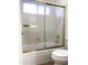 Shower and tub, framed by sliding glass doors, with tile flooring at 1249 E Commerce Ave, Gilbert, AZ 85234